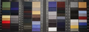Open swatch book with Ben, Palazzo, Irish linen and Charles Clayton cloths in green, mustard, navy, grey and burgundy