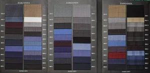 Open Zarganza swatch book with plain worsted wools in navy, grey, beige, blue and burgundy